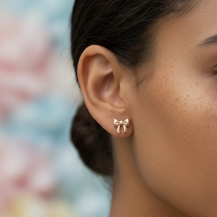 Close-up of a woman wearing a bow-shaped earring with a blurred background