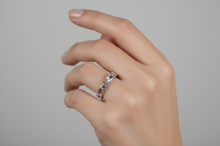 A gold eternity ring with diamond accents, featuring an organic, wave-like pattern.