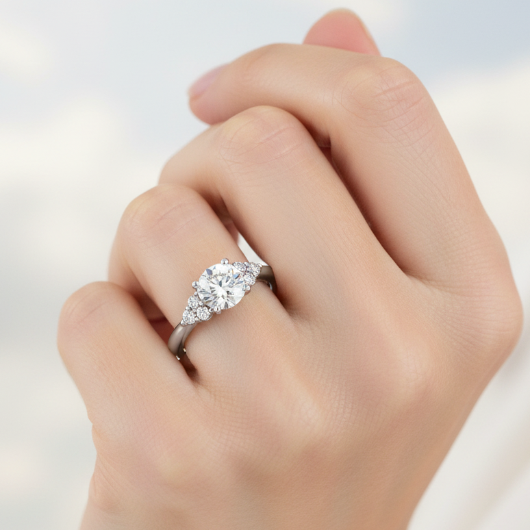 Platinum and diamond cluster style engagement ring on a woman's hand
