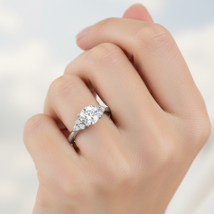 Platinum and diamond cluster style engagement ring on a woman's hand
